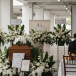 A serene funeral wake setup in Singapore with elegant floral arrangements and soft lighting, highlighting dignified funeral services.
