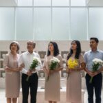 Multi-generational Singaporean family at a columbarium, discussing cremation services in Singapore