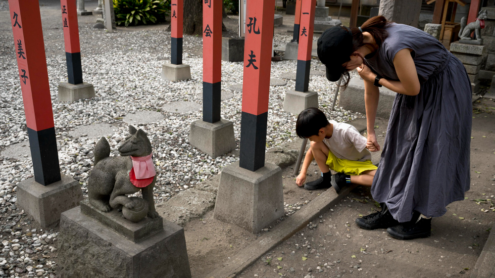 Adult and child visiting a shrine